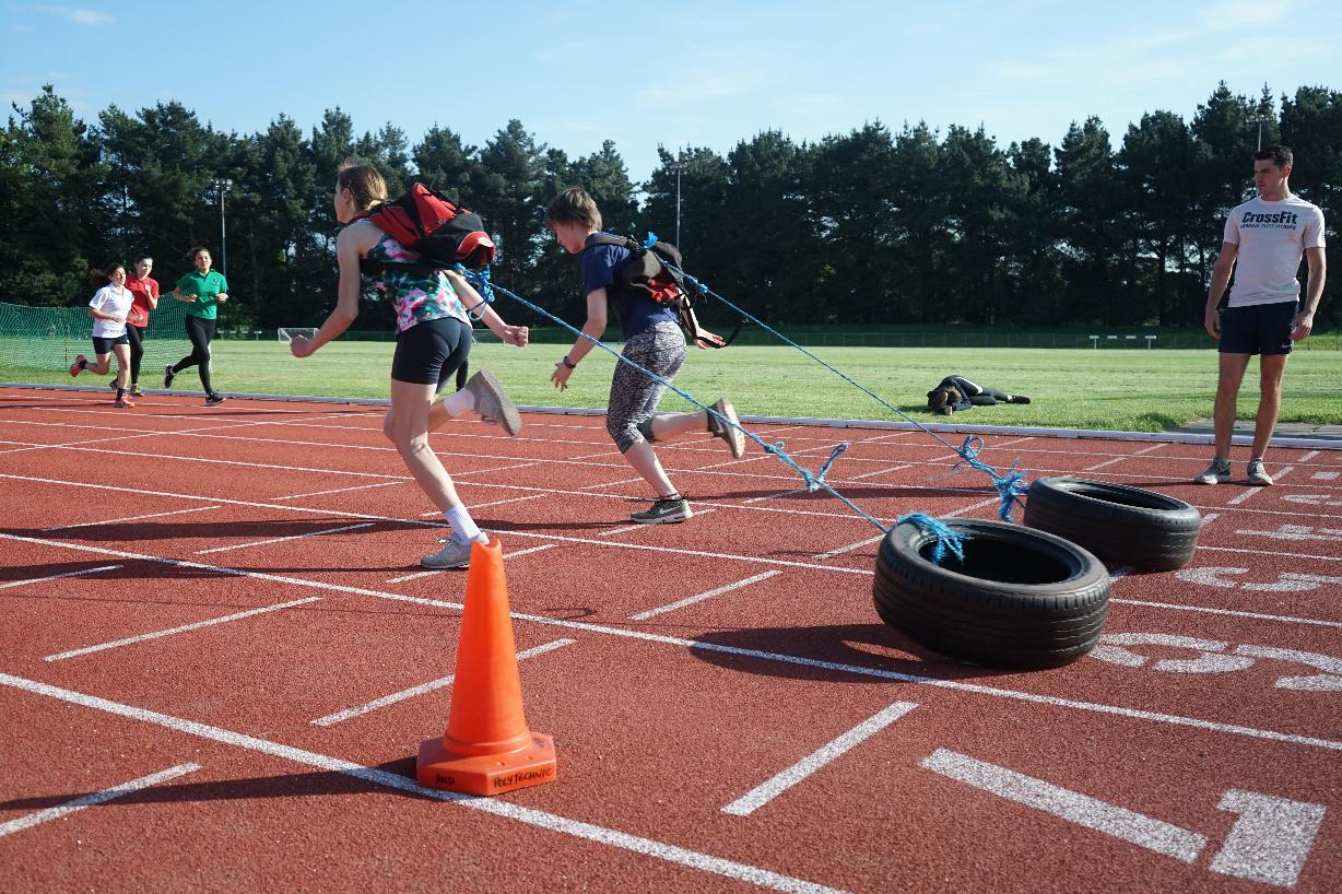 Young Athlete Running Tyre Pull